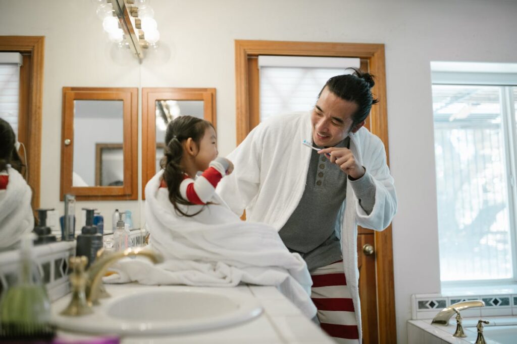 Father Guiding Daughter on Dental Hygiene