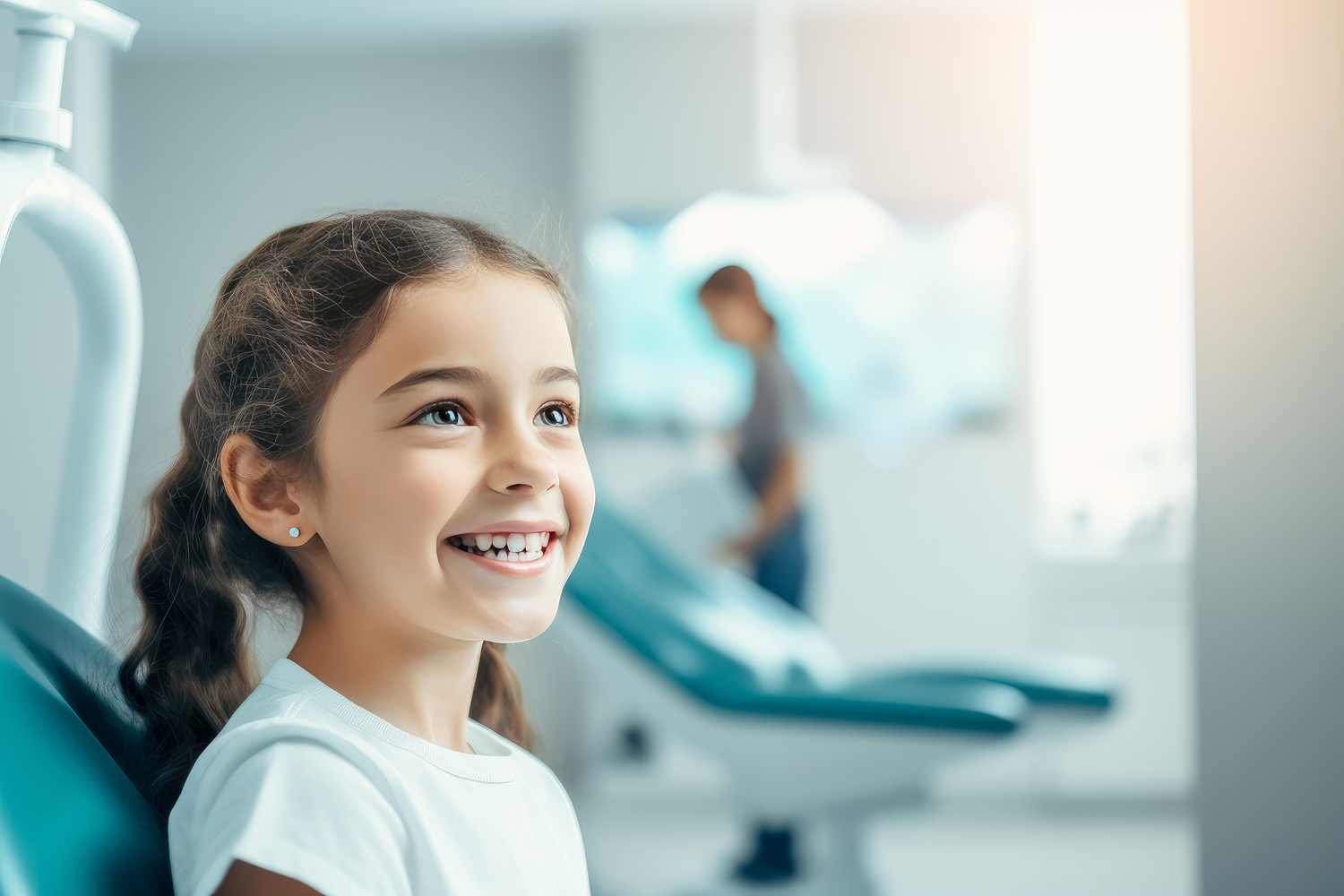 Young girl smiles at dentist, young girl sitting in dental office.