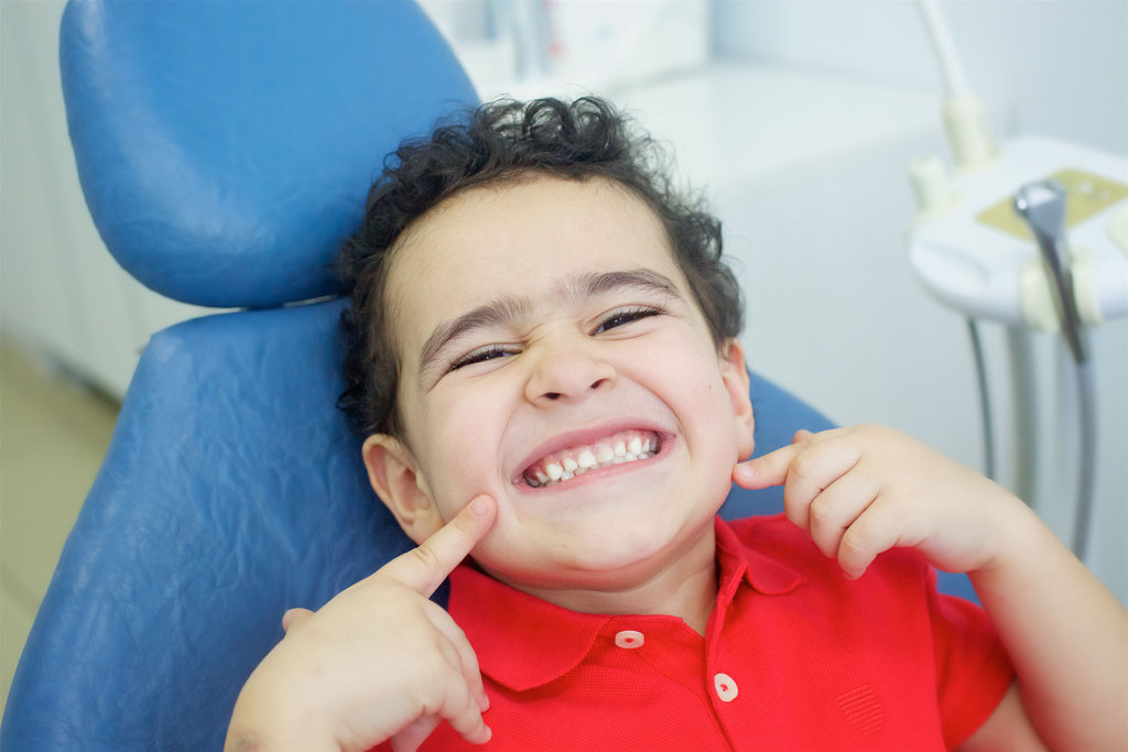 Playing dentist in the dental office. The patient is happy and satisfied.