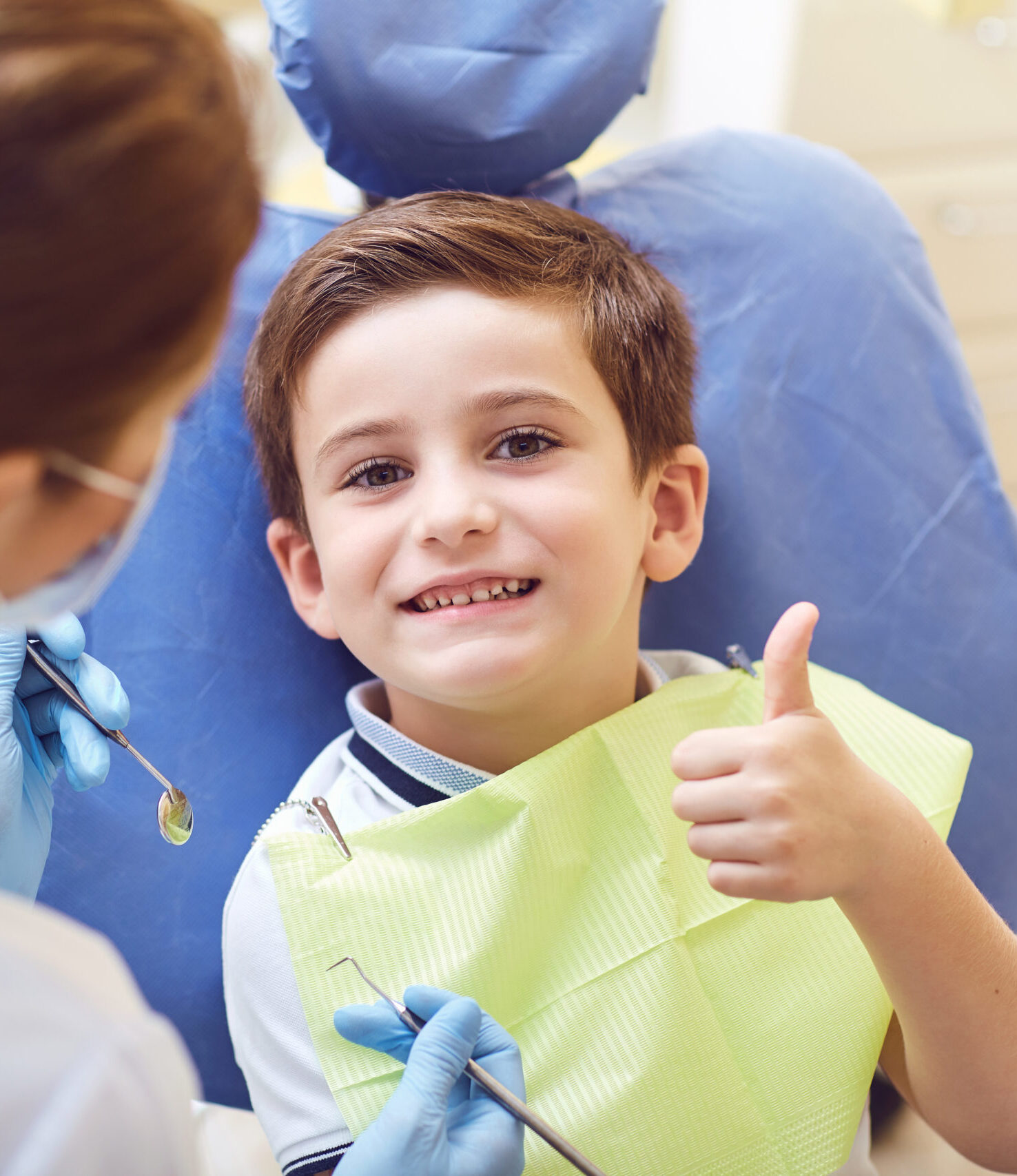 A child with a dentist in a dental office. Dental treatment in a children's clinic.